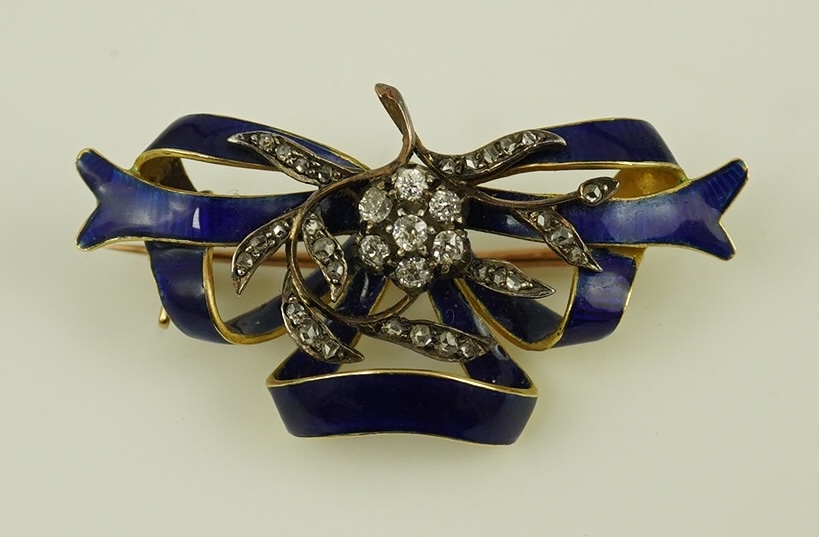 A Victorian gold, diamond cluster and blue enamel set ribbon bow brooch